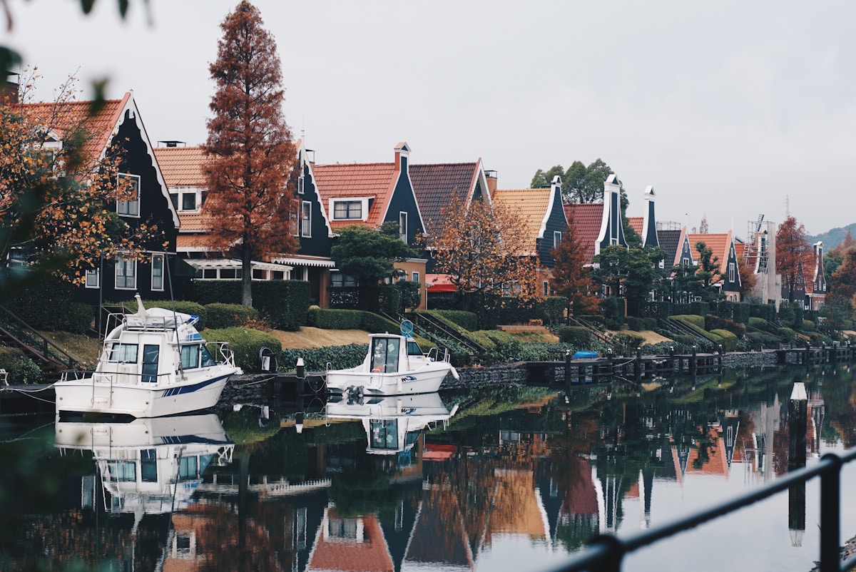Boats docked along a river in a traditional Japanese waterfront town
