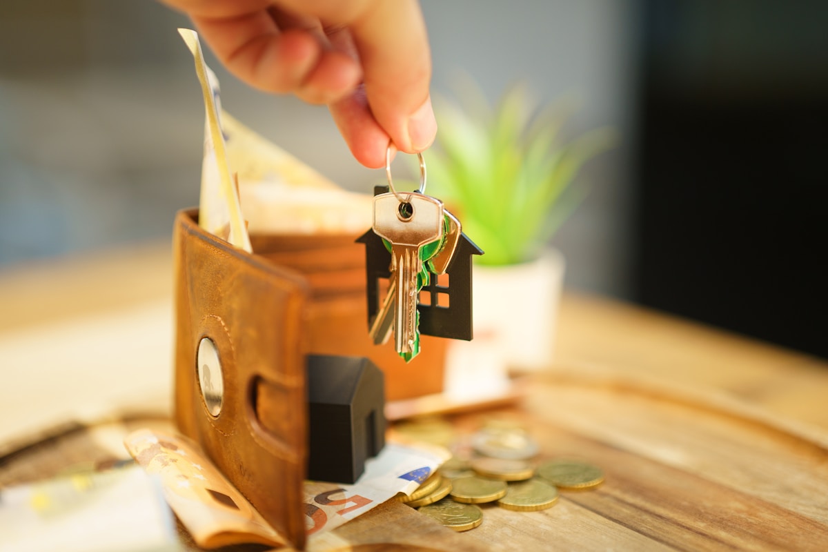 Hand holding house keys — representing property handover