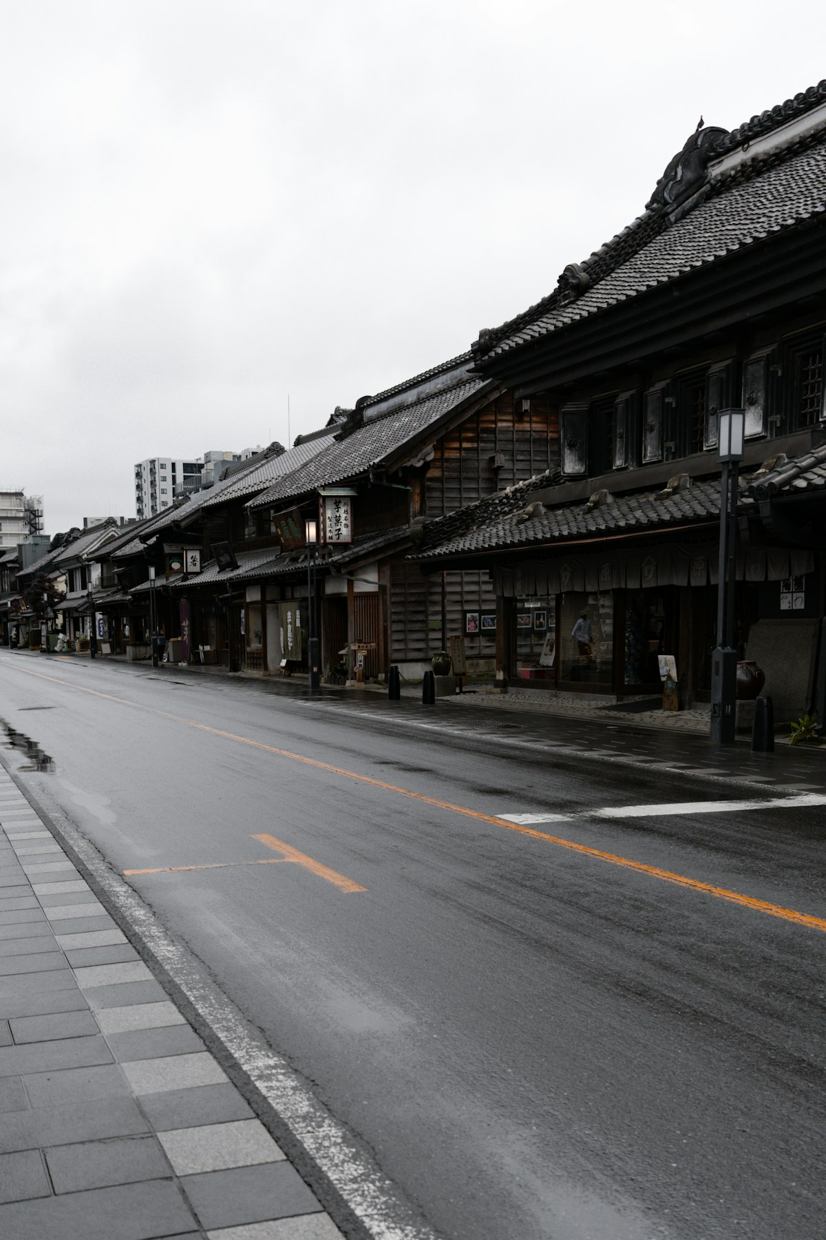 A quiet street lined with traditional Japanese buildings in Kawagoe