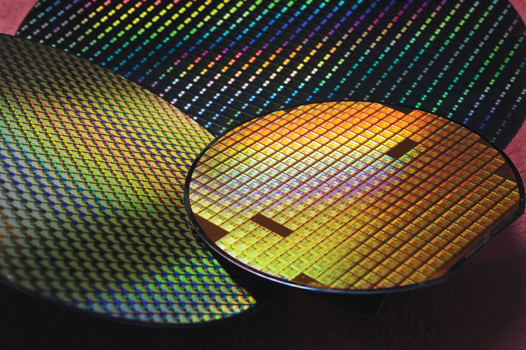 TSMC semiconductor wafers — iridescent silicon discs produced at JASM's Kumamoto facility using 12nm to 28nm process nodes