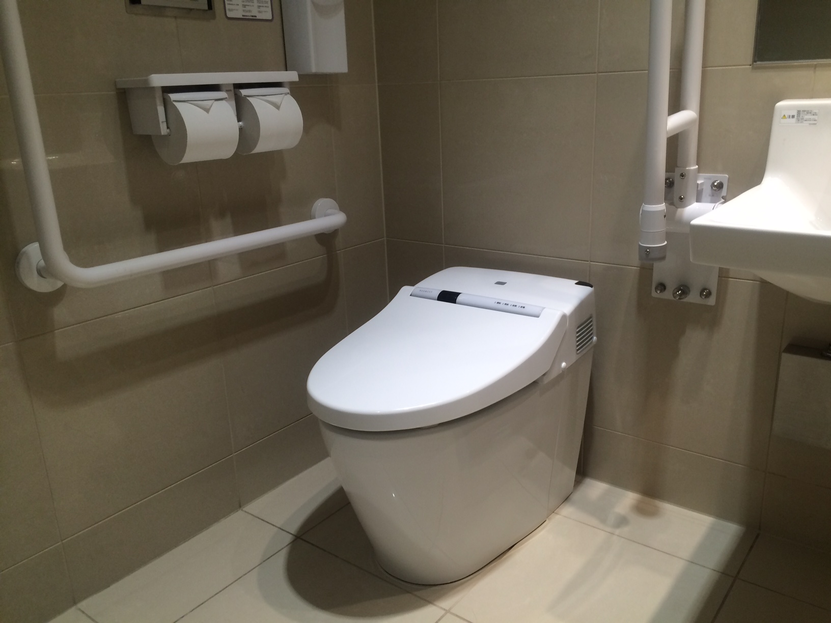 Modern integrated TOTO washlet toilet in a contemporary Japanese restroom