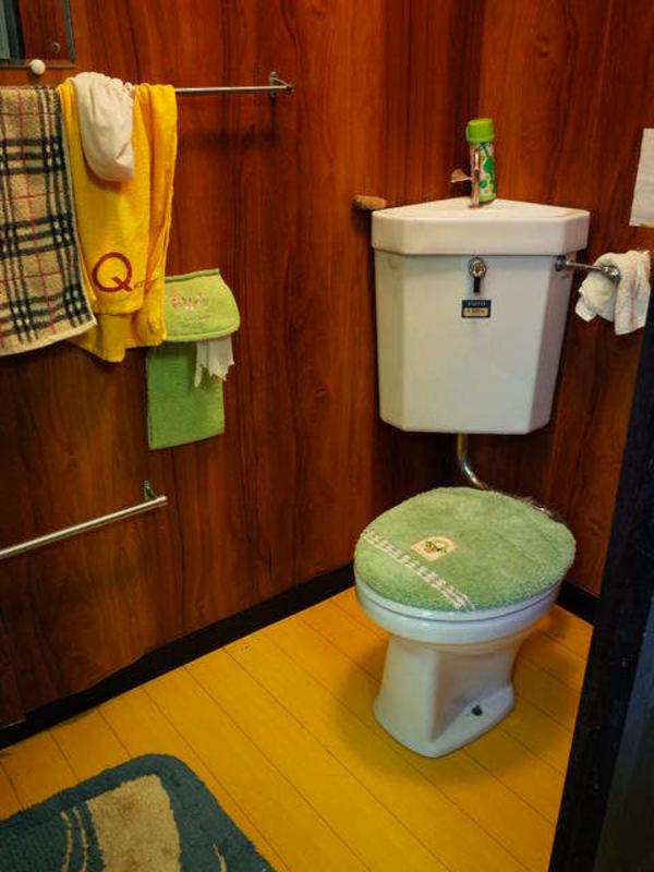 Vintage wall-mounted cistern toilet in a Japanese house